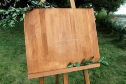 Copy space, your text here. Wooden easel with a board. 