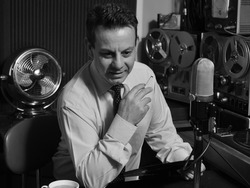 A Cool 1950's 60's Retro Radio DJ plays music while holding record and cigarette 