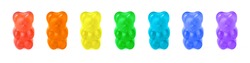 Row of seven gummy bears painted in rainbow colors isolated on white