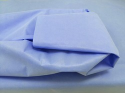 Packing Of Surgical Instrument With Sterilization Blue Drape Sheet. Selective Focus
