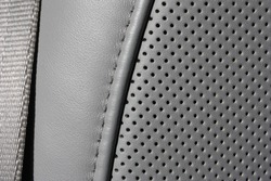 Car light gray perforated natural leather seat extreme close-up