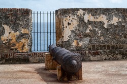 A cannon pointed out into the Caribbean sea from the top of el Morro fortress in San Juan, Puerto Rico.