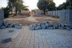 Concrete pavers being used to replace a dirt road