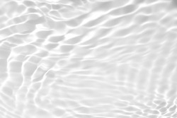 Closeup of desaturated transparent clear calm water surface texture with splashes and bubbles. Trendy abstract nature background. 