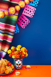 Day of the dead, Dia De Los Muertos Celebration Background With marigolds or cempasuchil flowers in vase with skull, bread of death or Pan de Muerto with Copy Space. Traditional Mexican culture 