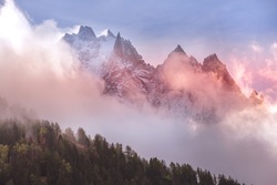 Fantastic evening snow mountains landscape background. Colorful pink and blue clouds overcast sky. French Alps, Chamonix Mont-Blanc, France