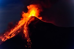 Lava spurts from erupting Fuego volcano at dawn near Antigua, Guatemala, Central America