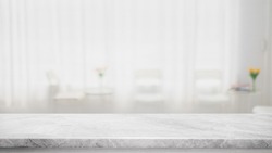 Empty white marble stone table top and blur glass window interior cafe and restaurant banner mock up abstract background - can used for display or montage your products.