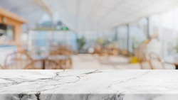 White marble stone table top and blurred restaurant interior background - can used for display or montage your products.