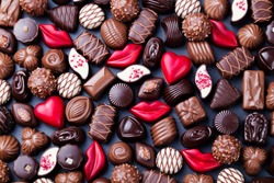 Assortment of fine chocolate candies, white, dark and milk chocolate. Sweets background. Copy space. Top view.