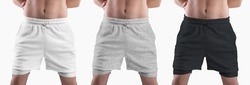 Mockup of white, black, heather loose shorts with compression line on athletic male body, isolated on background. Set. Clothing template with underpants, front view