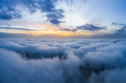 Beatuful dawn sky over clouds high. Aerial cloudscape photography.