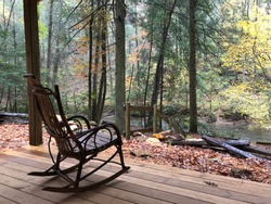 Rocking chair on porch next to river