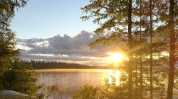 Serene Lake at Sunset or Sunrise, Sun Reflecting in the Water