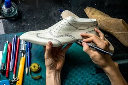 Drawing on a handmade shoe form in a leather shoe workshop