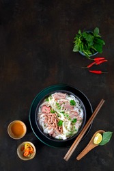 Beef noodle soup is Pho Bo, Vietnamese famous street food include : Rice noodle, beef, herb in delicious broth. Serving with chili, chili sauce, lime. Image ready for cover, avatar design