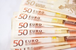 a lot of euro banknotes on white. 50 euros on the table. Money background. Close-up. Selective focus.