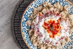 Manti Turkish Ravioli Kayseri with yogurt and chili sauce 