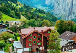Wengen in the swiss alps surrounded by mountains in a cloudy day
