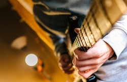 Guitarist plays the guitar. Focus on hands.Young man playing electric guitar