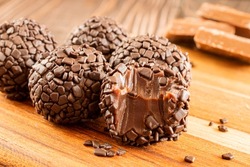 Brigadeiro (Brigadier) Traditional brazilian sweet. Chocolate candy on woody background.