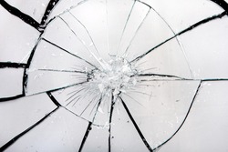 Broken glass with white reflection and black cracks. Artistic background