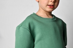 Close up detail of a warm boy sweatshirt. White background. Details of clothes for boys, sports suit for a student. Children's fashion concept. Place for your text. Banner.