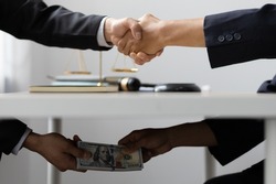 Business people shaking hands and Give an under-the-table bribe to an attorney to help a lawyer win a court case. Bribery and Kickback Ideas Fraud and Fraud