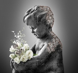 Bouquet of roses in the hands of an angel sculpture, symbol of faith and love	