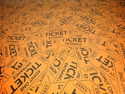 A background of orange vintage style tickets. For movie, concert, plays, and carnivals.