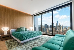 Modern and contemporary bedroom in Brooklyn, New York with views of upper Manhattan. Condo or Hotel accommodation. Sage Green and maple colors.