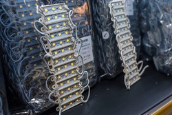 12 volt epoxy LED modules lights on display at an electronics store. An array of light emitting diodes strips.