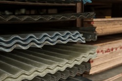 Well stocked supplies of Corrugated GI (Galvanized Iron Sheets) and supplies of 8x4 plywood sheets at a hardware store.