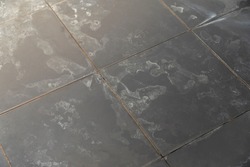 Dry water stains on the tile floor in the bathroom