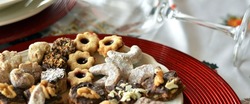 Lovely close up image of Christmas cookies on a plate and wine glass on a table