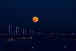 
red moon. red moon on the Bosphorus bridge in Istanbul. Bosphorus view. dark weather. selective focus