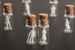 Covid-19 epidemic, protection of older and more vulnerable people, concept. Elderly couple figures inside a glass bottle