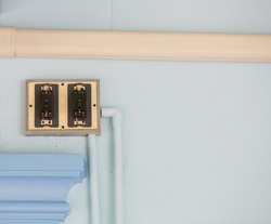 Two electrical disconnect switches installed on the blue wall