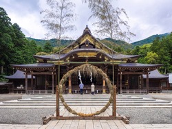 Main shrine and cogon grass ring (through which people pass as purification rite) (Yahiko shrine, Yahiko, Niigata, Japan)