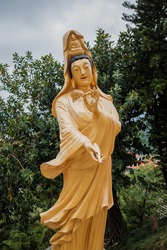 Old Guanyin, Traditional Chinese Goddess Golden Statue in temple, outdoor, daytime