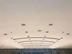 Curved Gypsum false ceiling designs of an buildings like shopping mall public building interiors and architecture painted with emulsion painted smooth matt finish
