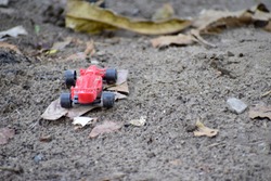 Red toy car on the ground
