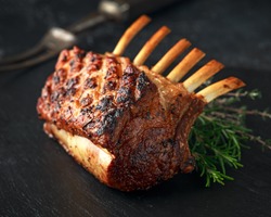 Lamb rack roasted with herbs on stone board