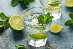 Mojito cocktail with Rum, lime and mint in glass. Summer cold drink with ice