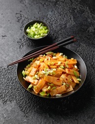 Spicy bamboo shoot salad in black bowl. Asian food.