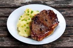 Rare beef steak with mashed potatoes.