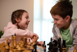 Chess game for clever mind. Kids having great time together playing chess. Logic development, leisure board games, entertainment, intelligent hobby and education concept