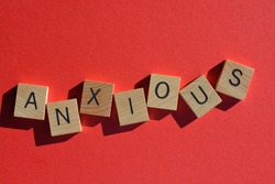 Anxious, word in wooden alphabet letters isolated on bright red background