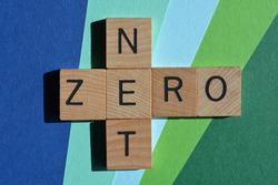 Net Zero, words in wooden alphabet letters in crossword form isolated on green and blue background