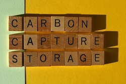 CCS acronym for Carbon Capture Storage, words in wooden alphabet letters isolated on green and yellow background 